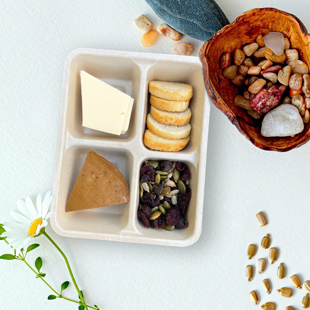 Open tray of C’est La Ve vegan Italian charcuterie Luncherie snack, including sun-dried tomatoes deli slices, mozzarella slices, bruschetta, and nut free trail mix.