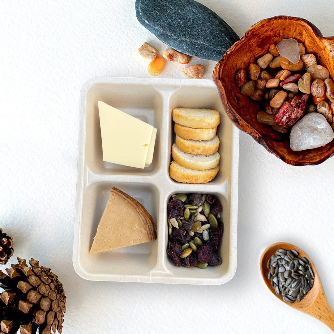 Open tray of C’est La Ve vegan smoked charcuterie Luncherie snack, including hickory smoked deli slices, smoked gouda slices, bruschetta, and nut free trail mix.