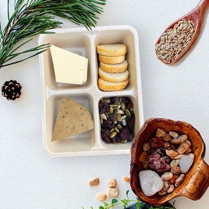 Open tray of C’est La Ve vegan Peppered charcuterie Luncherie snack, including black pepper deli slices, Provolone slices, bruschetta, and nut free trail mix.